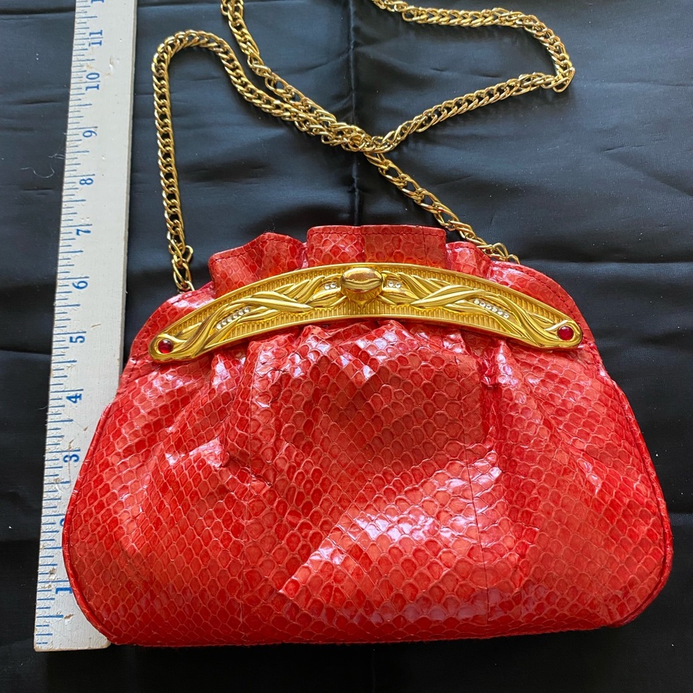 Elegant dyed red snake handbag w/ red leather lining. Gold frame w/knob lock.